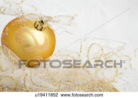 Stock Image - Golden Christmas bauble. Fotosearch