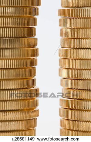 Stock Photo - Golden coins in stacks, studio shot. Fotosearch