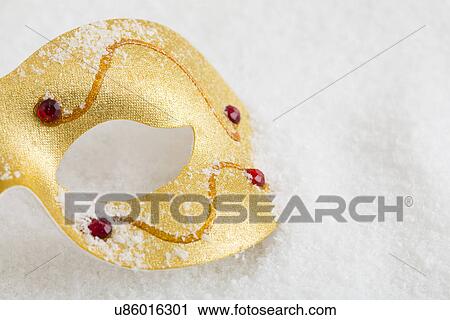 Stock Image - Golden mask on snow. Fotosearch