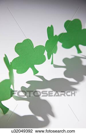 Stock Image - Green paper shamrocks. Fotosearch