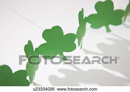 Stock Photograph - Green paper shamrocks. Fotosearch
