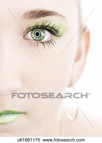 Stock Photography - Half of girl's (14-15) face with green eye and make-up. Fotosearch