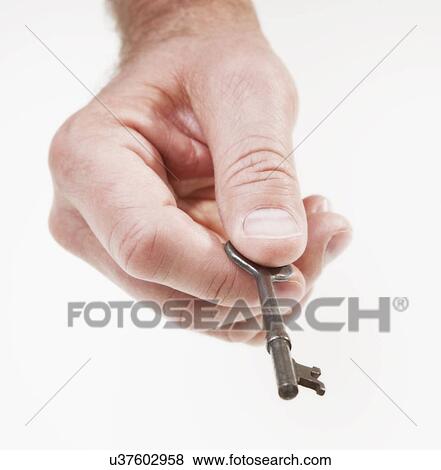Hand holding antique key View Large Photo Image Stock Photo - Hand holding antique key. Fotosearch