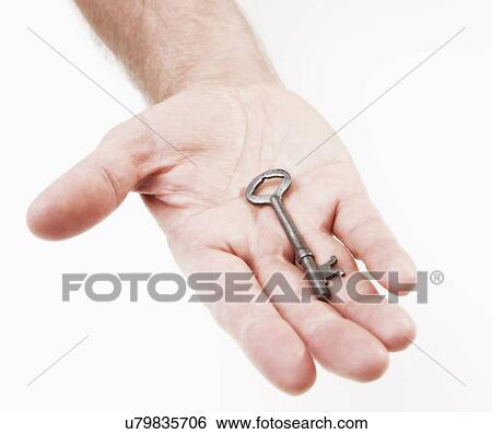 Hand holding antique key View Large Photo Image Stock Photograph - Hand holding antique key. Fotosearch