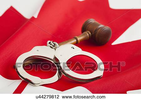 Handcuffs and gavel on Canadian flag View Large Photo Image Stock Image - Handcuffs and gavel on Canadian flag. Fotosearch