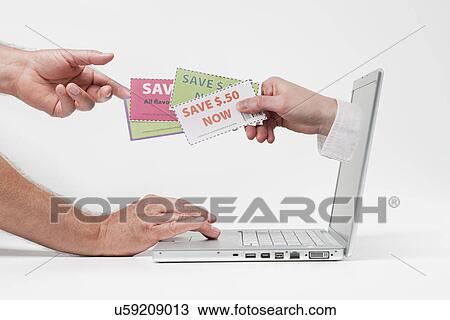 Stock Image - Hands, coupons and laptop. Fotosearch
