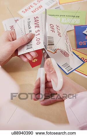 Hands cutting out coupon View Large Photo Image Stock Image - Hands cutting out coupon. Fotosearch