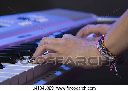 Hands of female musician playing keyboard View Large Photo Image Stock Photo - Hands of female musician playing keyboard. Fotosearch