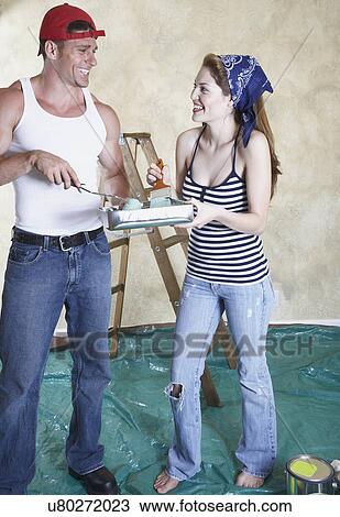 Happy couple painting room View Large Photo Image Stock Image - Happy couple painting room. Fotosearch