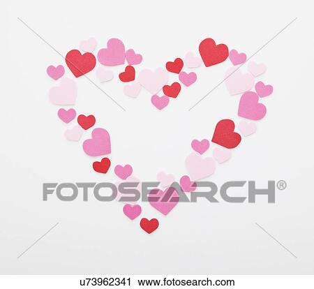 Heart shape arranged with pink and red hearts on white background View Large Photo Image Stock Image - Heart shape arranged with pink and red hearts on white background. Fotosearch
