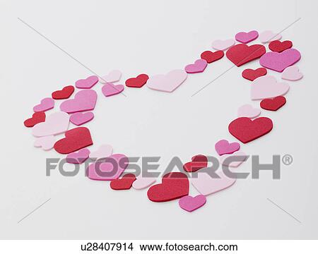 Picture - Heart shape arranged with pink, red and white hearts on white background. Fotosearch