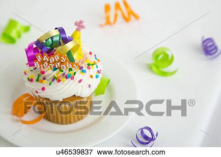 Stock Photo - High angle view of birthday cupcake. Fotosearch