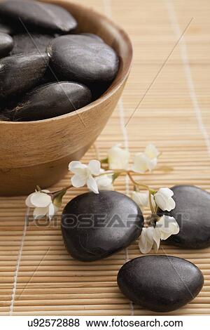 Stock Photo - hot stone therapy stones in spa, Studio shot. Fotosearch