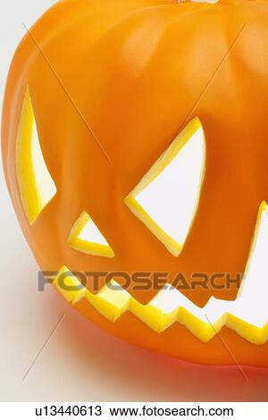 Stock Image - Illuminated jack o' lantern. Fotosearch