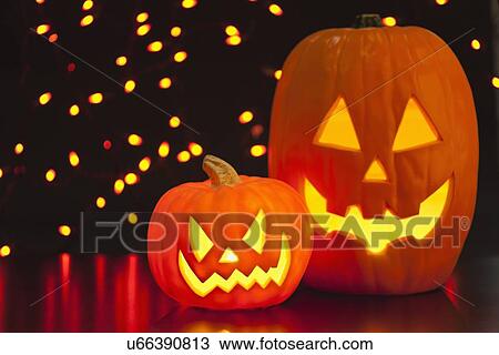 Stock Image - Illuminated jack o' lanterns. Fotosearch