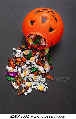 Jack o' lantern basket spilling candies View Large Photo Image Stock Image - Jack o' lantern basket spilling candies. Fotosearch