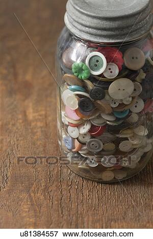 Stock Photo - Jar of buttons on table. Fotosearch