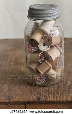Jar of thread and reels on table View Large Photo Image Picture - Jar of thread and reels on table. Fotosearch