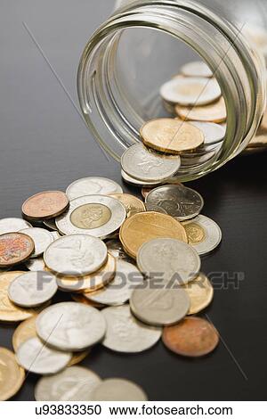 Stock Image - Jar with coins. Fotosearch