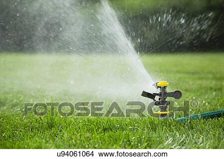 Lawn sprinkler View Large Photo Image Picture - Lawn sprinkler. Fotosearch
