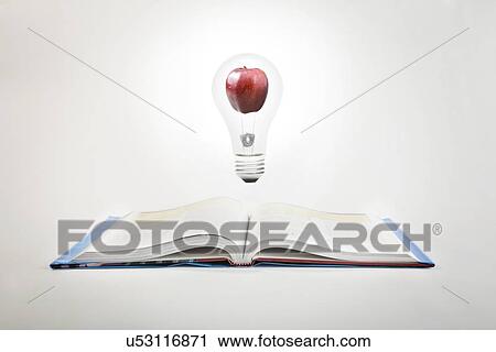 Lightbulb and apple levitating over open book View Large Photo Image Stock Image - Lightbulb and apple levitating over open book. Fotosearch