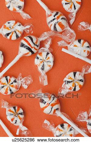 Stock Photograph - Lollipops on orange background. Fotosearch