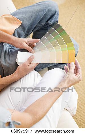 Low section of couple holding color samples, elevated view View Large Photo Image Stock Photo - Low section of couple holding color samples, elevated view. Fotosearch
