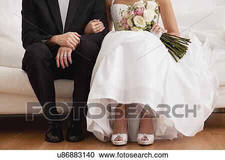 Stock Image - Low section of newly wed couple. Fotosearch