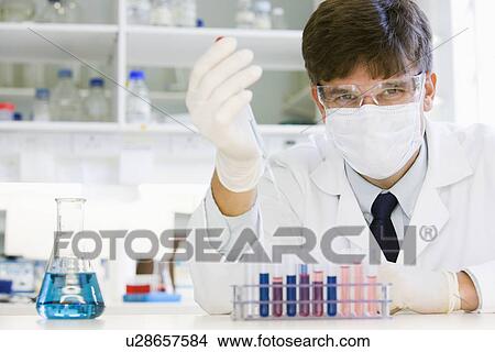 Picture - Male scientist doing research in laboratory. Fotosearch