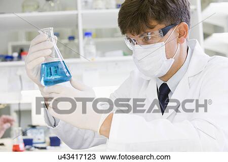 Stock Image - Male scientist doing research in laboratory. Fotosearch