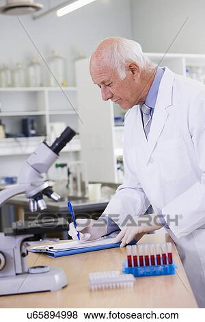 Male scientist doing research in laboratory View Large Photo Image Stock Photo - Male scientist doing research in laboratory. Fotosearch
