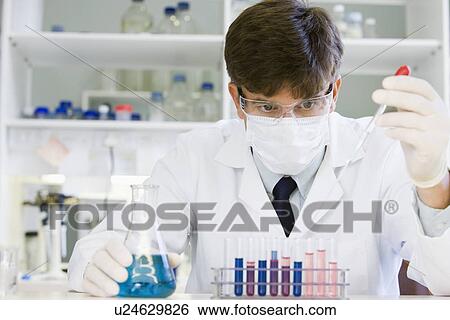 Stock Photograph - Male scientist doing research in laboratory. Fotosearch