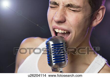 Picture - Male singer on stage. Fotosearch