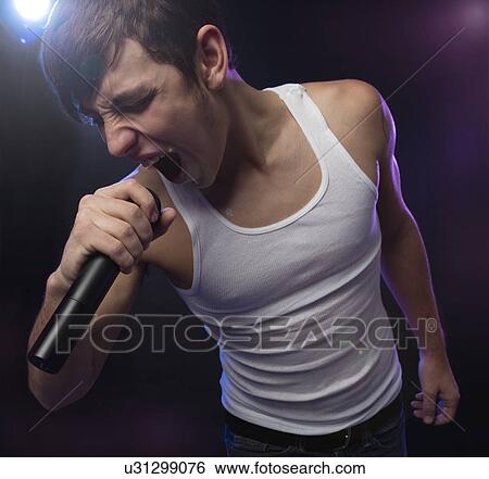 Stock Photograph - Male singer on stage. Fotosearch