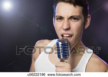Stock Photograph - Male singer on stage. Fotosearch