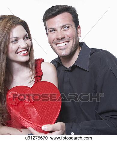 Man giving Valentine's gift to woman View Large Photo Image Stock Image - Man giving Valentine's gift to woman. Fotosearch