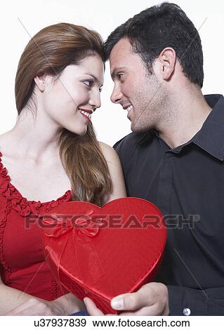Man giving Valentine's gift to woman View Large Photo Image Stock Photo - Man giving Valentine's gift to woman. Fotosearch