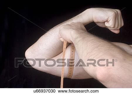 Man measuring bicep View Large Photo Image Stock Image - Man measuring bicep. Fotosearch