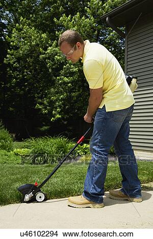 Man mowing grass in back yard View Large Photo Image Picture - Man mowing grass in back yard. Fotosearch