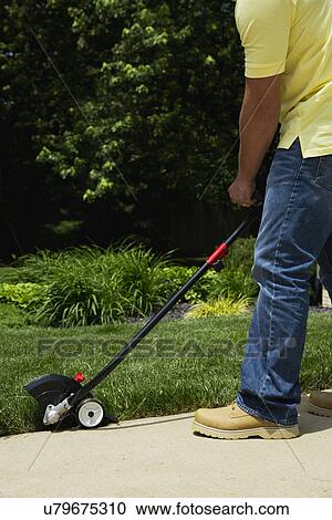Man mowing grass in back yard View Large Photo Image Stock Image - Man mowing grass in back yard. Fotosearch