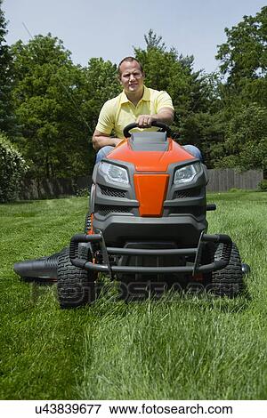 Man mowing lawn View Large Photo Image Stock Photo - Man mowing lawn. Fotosearch