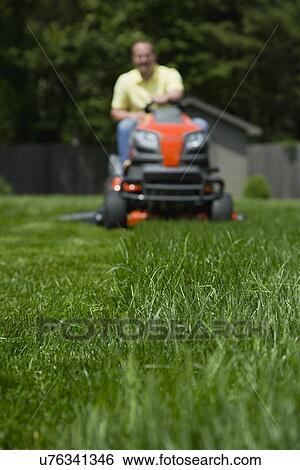 Man mowing lawn View Large Photo Image Stock Photograph - Man mowing lawn. Fotosearch