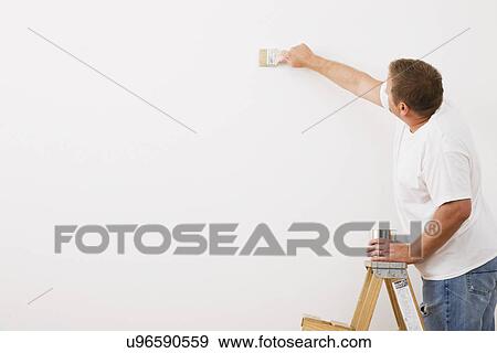 Man painting wall View Large Photo Image Stock Photo - Man painting wall. Fotosearch