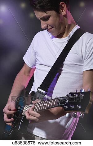 Stock Photograph - Man playing electric guitar. Fotosearch