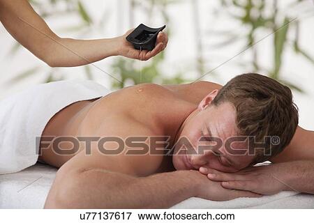Stock Photo - Man receiving massage, close-up. Fotosearch