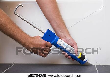 Man using caulking gun, close-up View Large Photo Image Stock Photo - Man using caulking gun, close-up. Fotosearch