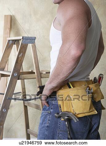 Man wearing tool belt, mid section View Large Photo Image Stock Photo - Man wearing tool belt, mid section. Fotosearch