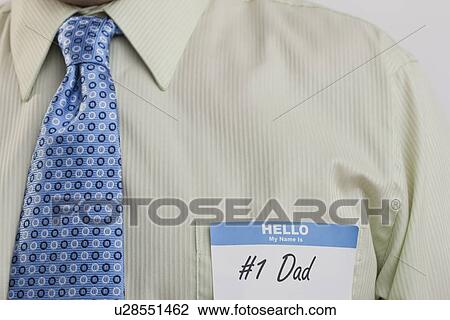 Man with 'number 1 dad' card on shirt View Large Photo Image Stock Image - Man with 'number 1 dad' card on shirt. Fotosearch