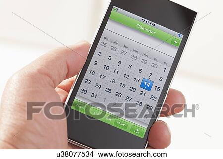 Man's hand holding smart phone View Large Photo Image Picture - Man's hand holding smart phone. Fotosearch