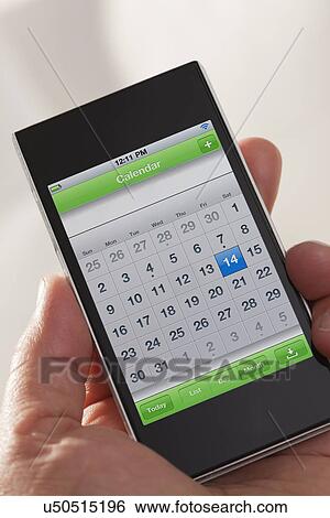 Stock Photograph - Man's hand holding smart phone. Fotosearch